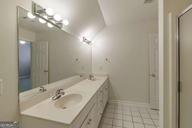 full bathroom with double vanity, a sink, and tile patterned floors