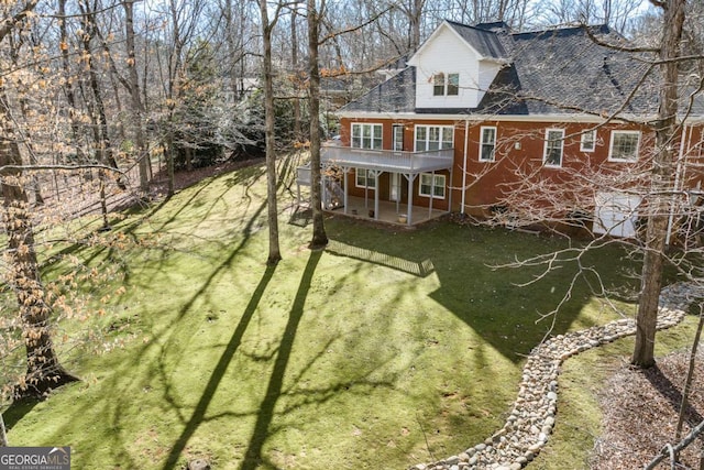 back of property featuring a patio area, dirt driveway, a lawn, and brick siding