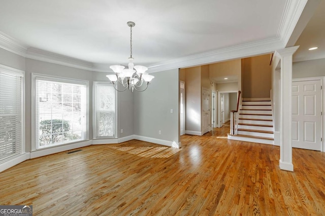 unfurnished dining area with visible vents, baseboards, stairs, light wood-style floors, and crown molding