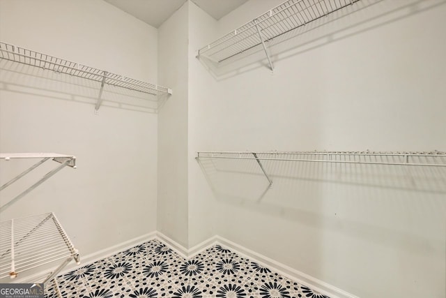 spacious closet with tile patterned floors