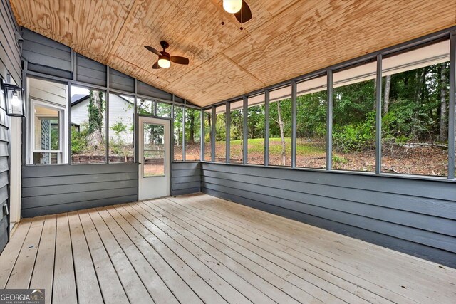 finished below grade area with a paneled ceiling, baseboards, wood finished floors, and recessed lighting