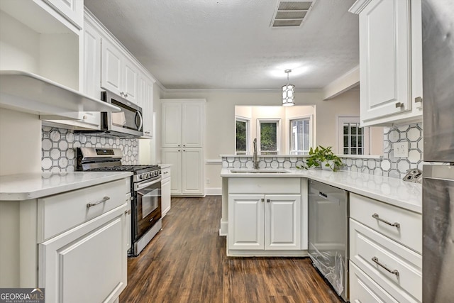 kitchen featuring visible vents, appliances with stainless steel finishes, white cabinets, and a sink