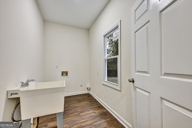 laundry area featuring hookup for a washing machine, laundry area, dark wood-type flooring, a sink, and baseboards