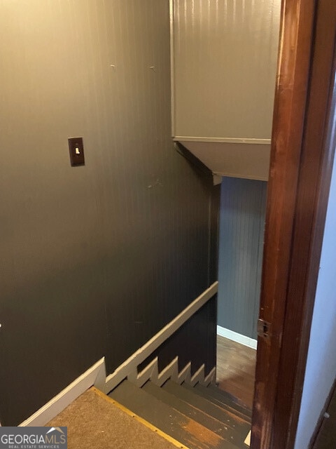 staircase featuring baseboards