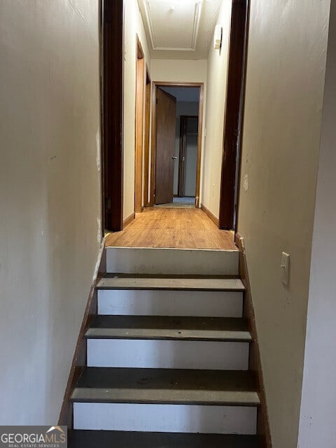 stairs featuring baseboards and wood finished floors