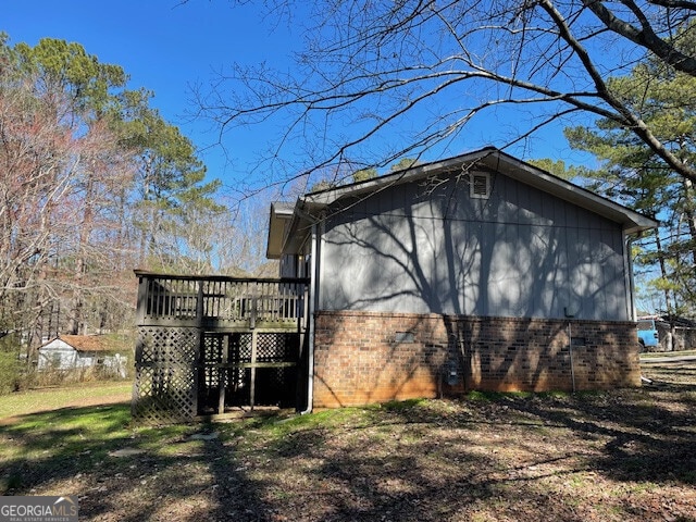 view of side of home featuring a wooden deck