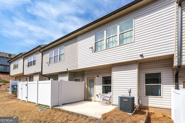 back of house featuring central AC unit, fence, and a patio