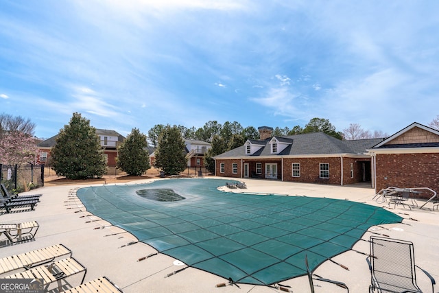 pool with fence and a patio