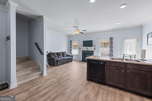 kitchen featuring a fireplace with flush hearth, a sink, light wood-style floors, black dishwasher, and ornamental molding