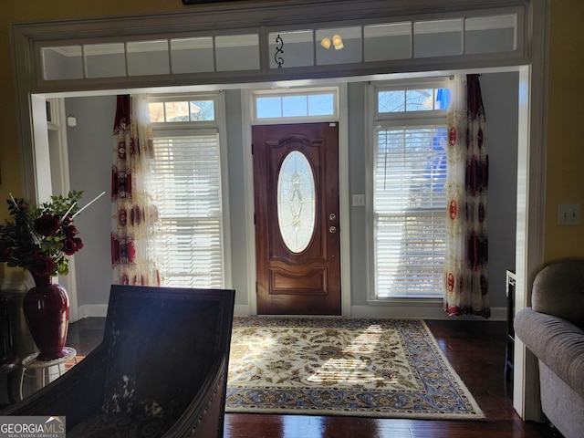 foyer featuring baseboards and wood finished floors