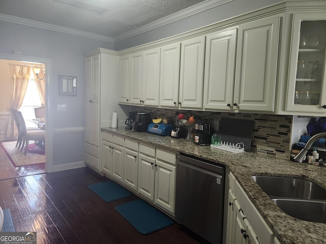 kitchen with dark wood-style floors, ornamental molding, a sink, dishwasher, and backsplash