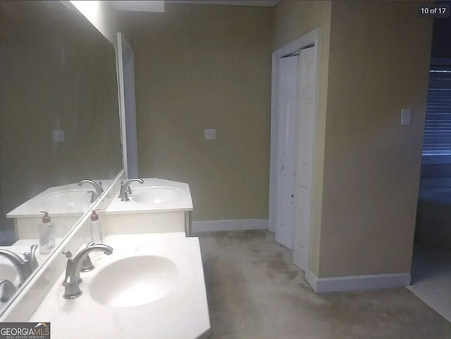 full bath with a sink and baseboards