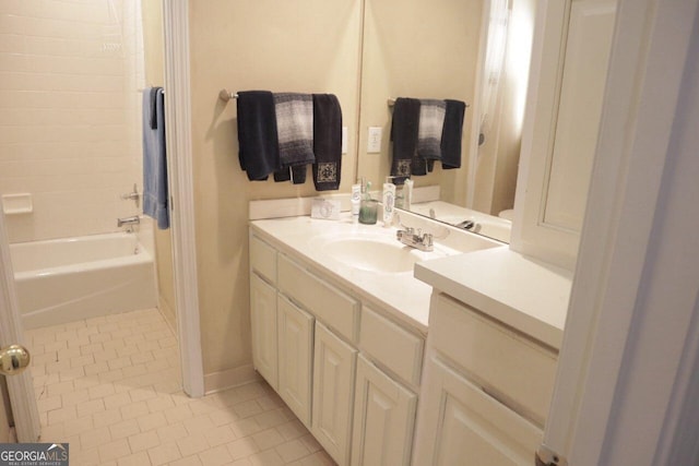 bathroom featuring washtub / shower combination, vanity, and tile patterned flooring