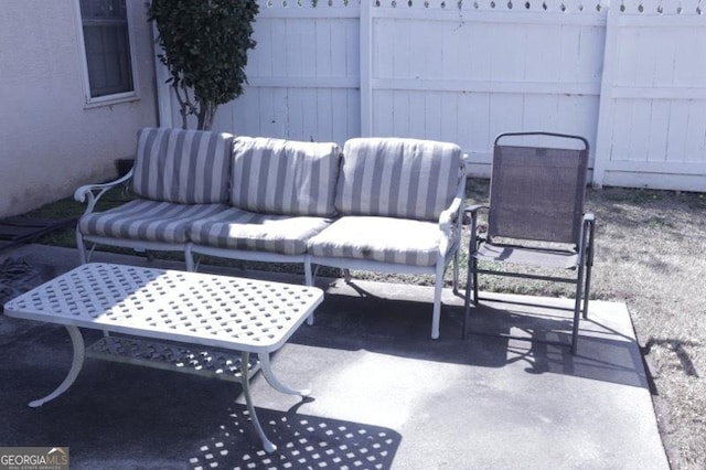 view of patio / terrace with an outdoor hangout area and fence