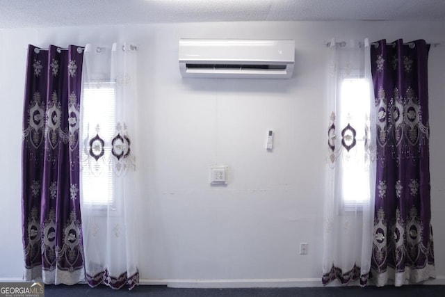 unfurnished room with plenty of natural light and a wall mounted AC