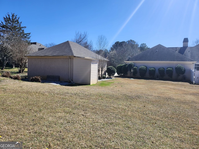 view of side of home with a lawn