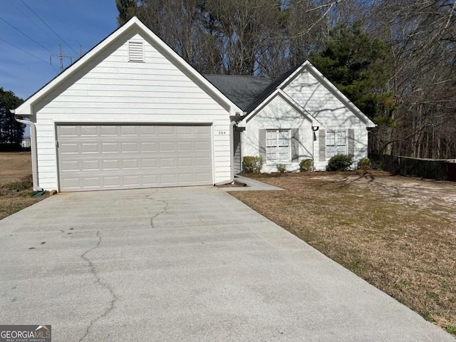 ranch-style home with a garage and driveway