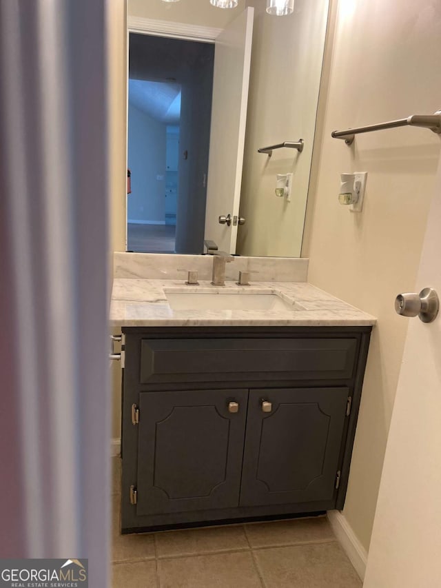 half bathroom featuring vanity and tile patterned floors