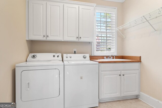 1020 Troublesome Creek Ln, Greensboro, GA 30642 - laundry area with baseboards, a sink, cabinet space, and washer and clothes dryer