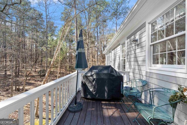 wooden deck featuring a grill