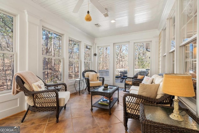 sunroom with visible vents, a wealth of natural light, and a ceiling fan