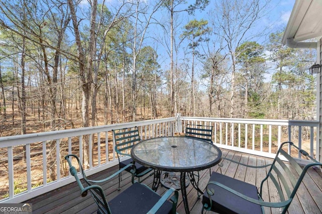 wooden terrace with outdoor dining area