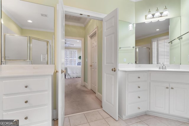 ensuite bathroom with ensuite bathroom, tile patterned flooring, vanity, ornamental molding, and a shower stall