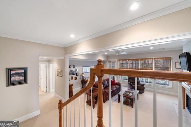 hall featuring light carpet, baseboards, and ornamental molding