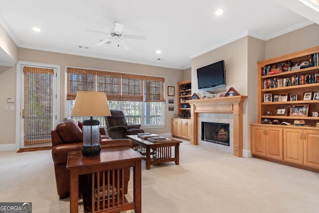 living area with recessed lighting, light colored carpet, ornamental molding, a tile fireplace, and baseboards