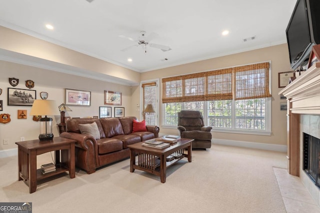 living room with recessed lighting, a fireplace, crown molding, and light colored carpet