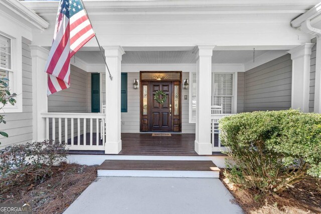 view of exterior entry with a porch