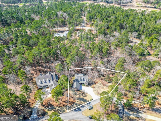 drone / aerial view featuring a forest view