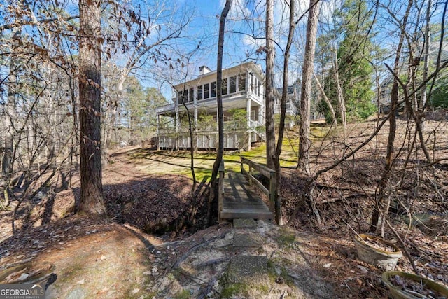 back of house featuring a chimney