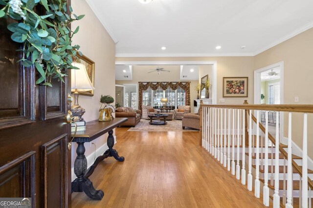 foyer featuring light wood-style floors, recessed lighting, and crown molding