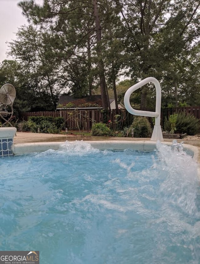 view of swimming pool with fence