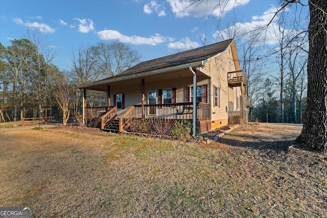 chalet / cabin with crawl space, covered porch, and a front lawn