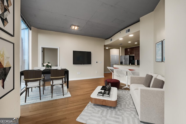 400 W Peachtree St NW Unit 3204, Atlanta, GA 30308 - living area with light wood-style flooring and baseboards