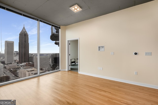 400 W Peachtree St NW Unit 3204, Atlanta, GA 30308 - unfurnished room with wood finished floors, expansive windows, and a view of skyline