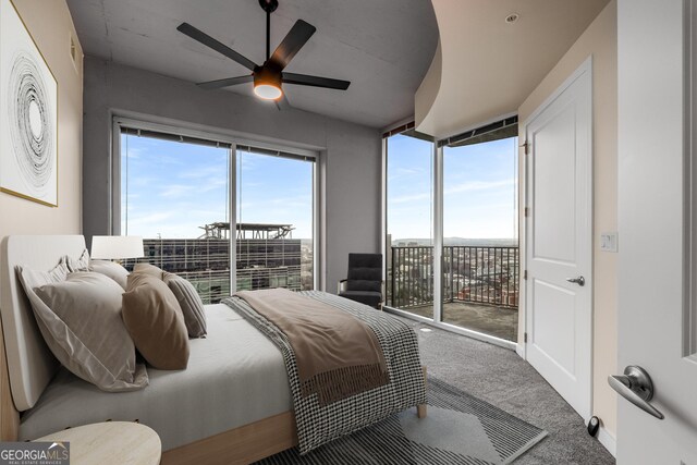 400 W Peachtree St NW Unit 3204, Atlanta, GA 30308 - carpeted bedroom with access to exterior, multiple windows, and a ceiling fan