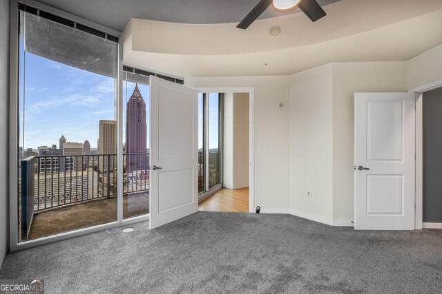 400 W Peachtree St NW Unit 3204, Atlanta, GA 30308 - carpeted spare room with plenty of natural light, ceiling fan, and a view of city