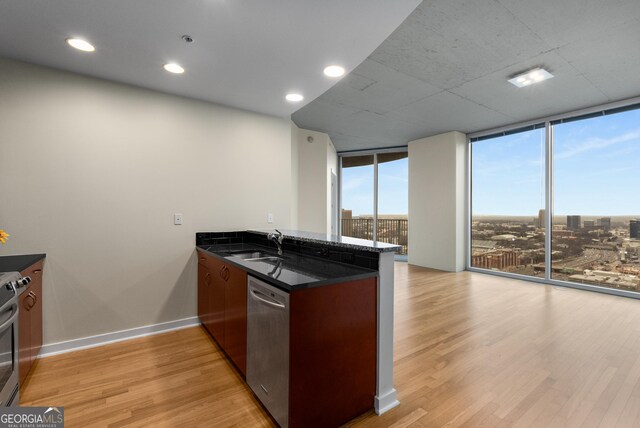 400 W Peachtree St NW Unit 3204, Atlanta, GA 30308 - kitchen featuring appliances with stainless steel finishes, a peninsula, floor to ceiling windows, light wood-style floors, and recessed lighting