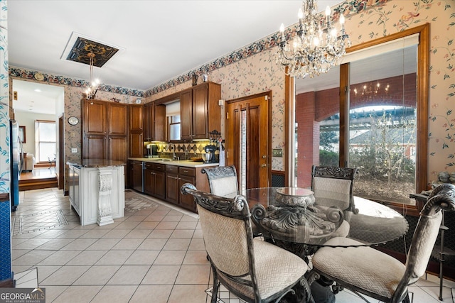 dining space with light tile patterned flooring, an inviting chandelier, and wallpapered walls