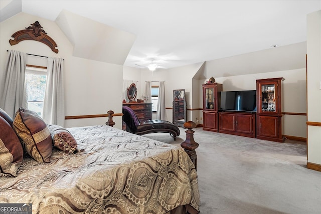 bedroom with carpet floors, vaulted ceiling, and baseboards