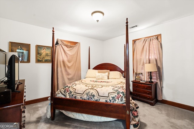 bedroom with carpet floors, visible vents, and baseboards