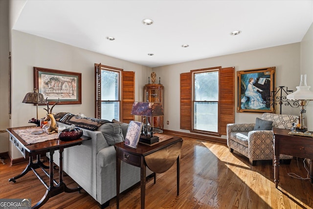 living room featuring plenty of natural light, baseboards, wood finished floors, and recessed lighting