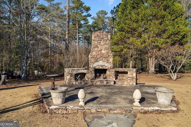 view of patio with an outdoor stone fireplace