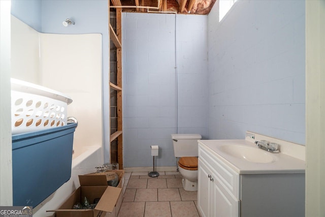 full bath with a tub, vanity, toilet, and tile patterned floors