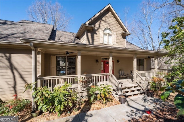 view of front facade featuring covered porch, ceiling fan, and a shingled roof