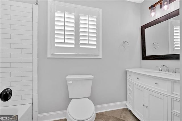 full bathroom with shower / bathtub combination, toilet, vanity, baseboards, and tile patterned floors