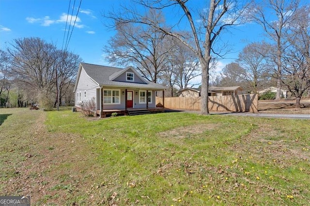 bungalow-style home with a porch, a front yard, and fence